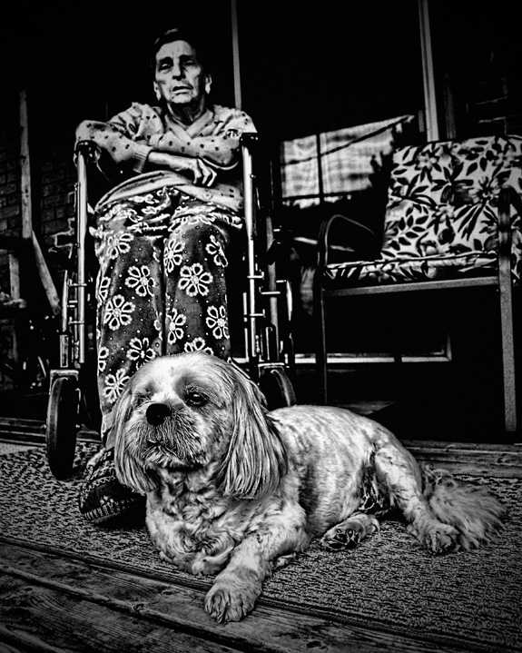 Old Woman in Wheelchair with Small Dog